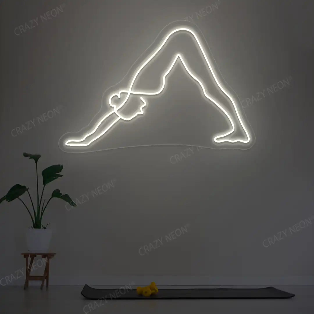 Adho Mukha Svanasana Yoga Neon Sign lighting up in warm white color in a yoga room