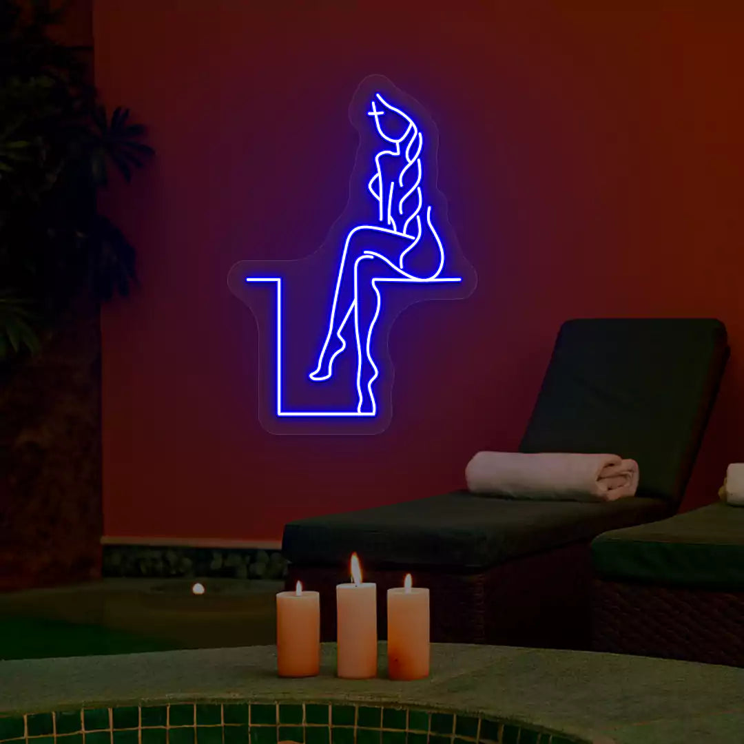 Blue Tranquil Lounge Spa neon sign glowing on a terracotta wall