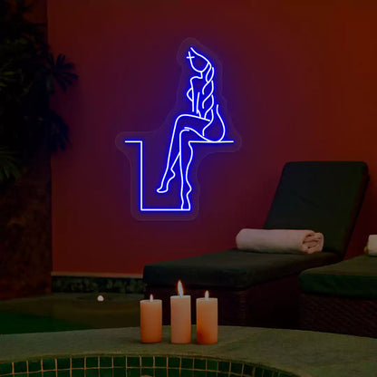 Blue Tranquil Lounge Spa neon sign glowing on a terracotta wall