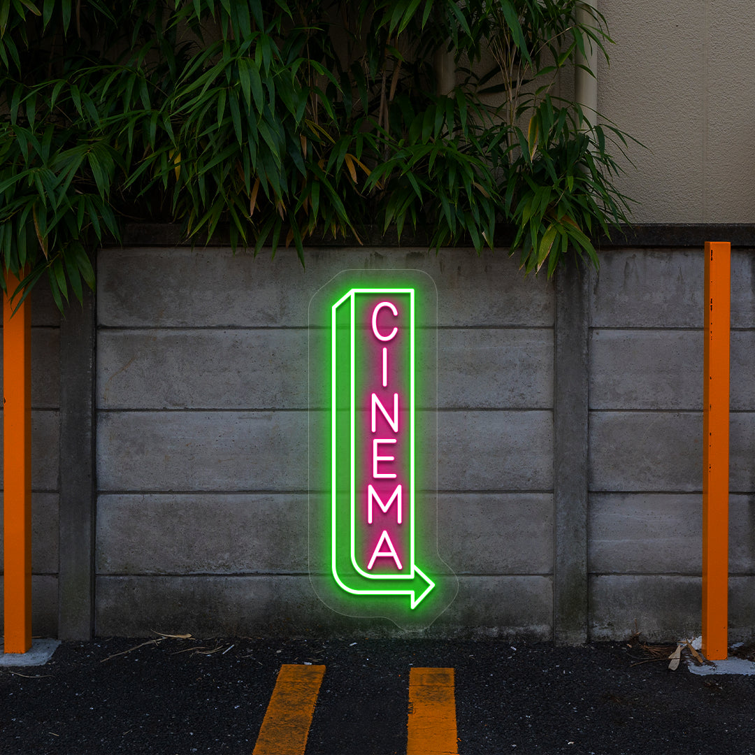 pink and green midnight cinema vintage neon sign mounted on a wall