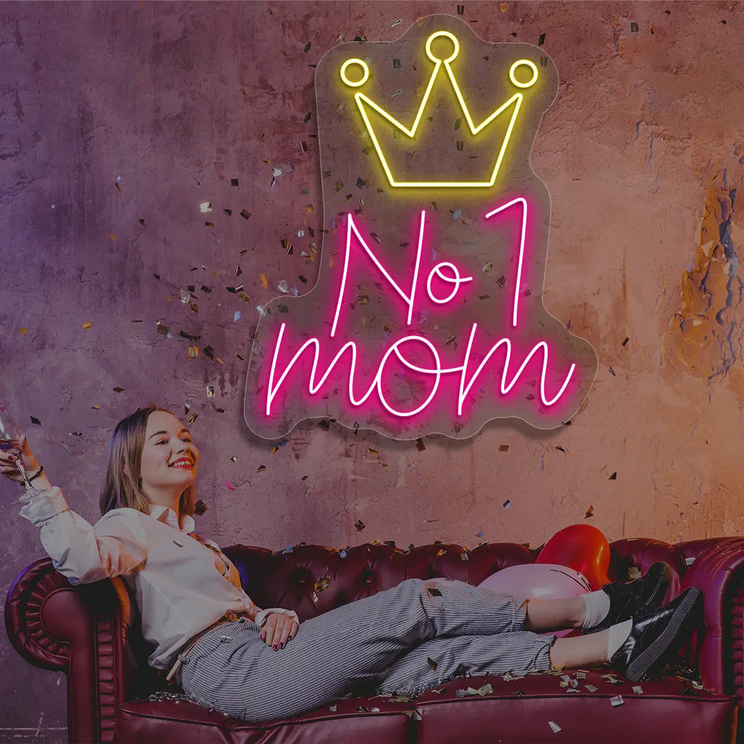 pink and yellow no 1 mom crown neon sign mounted on a wall