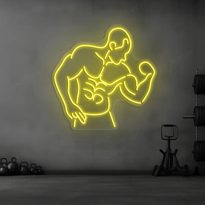 yellow muscle man flex neon sign mounted on a wall