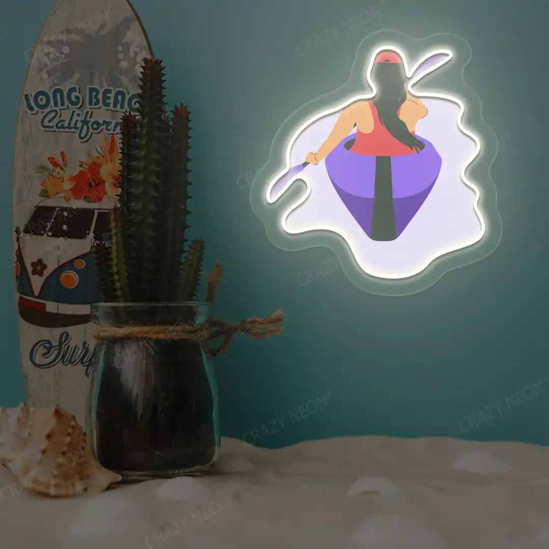 white woman kayaking neon artwork mounted on a wall