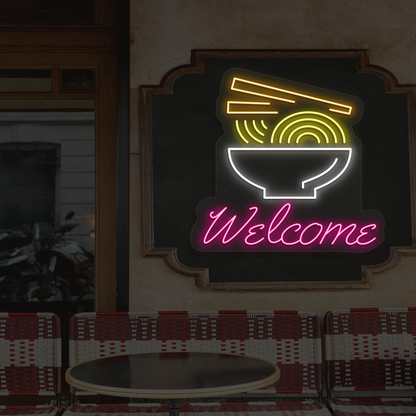 pink white yellow and orange welcome noodle bowl neon sign mounted on a wall