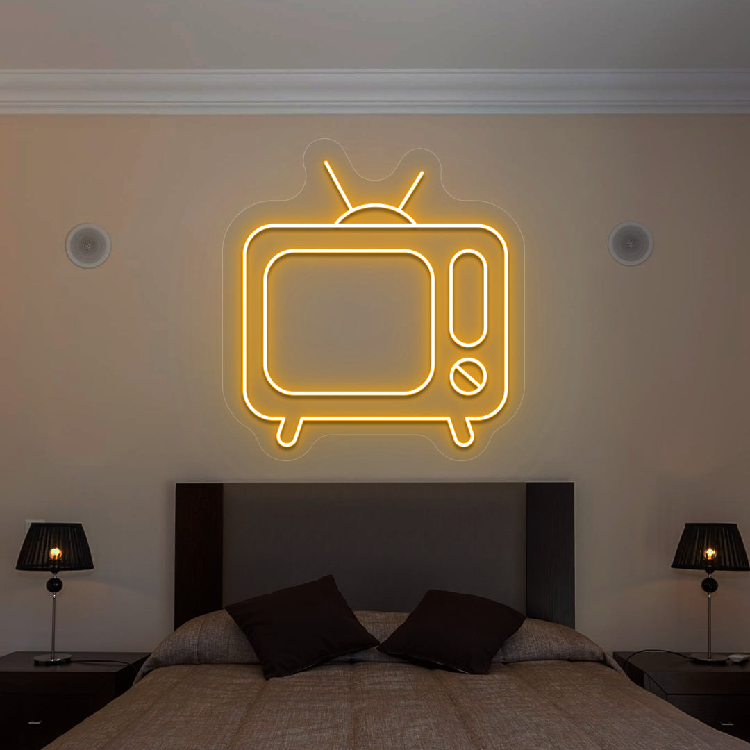 orange retro tv vintage neon sign mounted on a wall