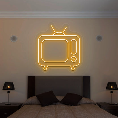 orange retro tv vintage neon sign mounted on a wall