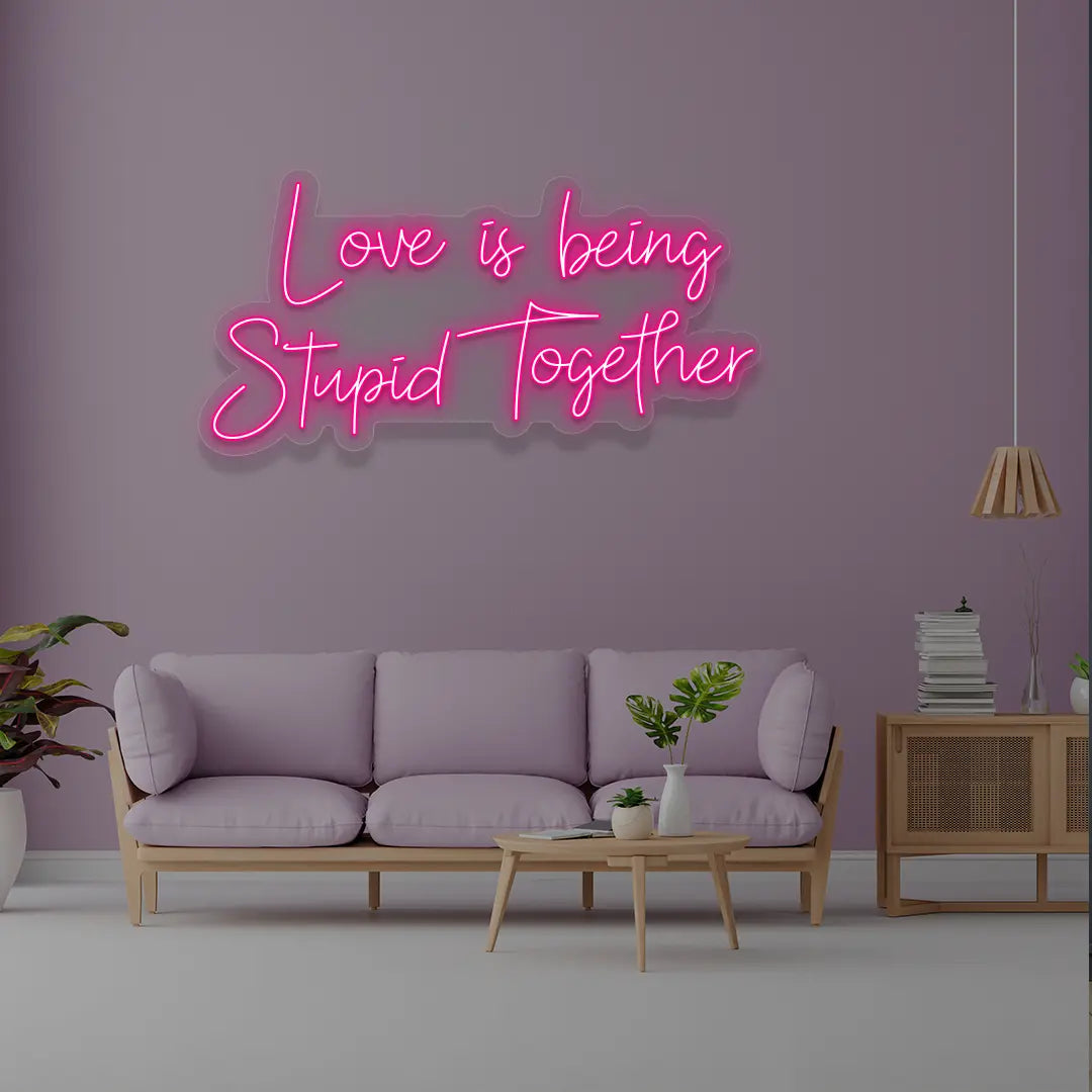 Love Is Being Stupid Together Neon Sign in Pink Color