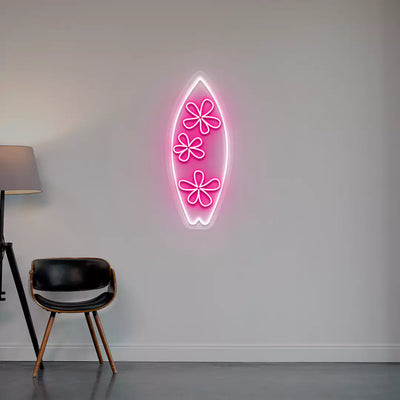 pink and white floral surfboard neon sign mounted on a wall