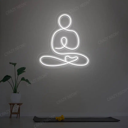 Swastikasana Yoga Neon Sign lighting up in white color in a yoga room