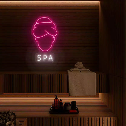 Serenity Face Spa neon sign in pink and white colors mounted in a spa room