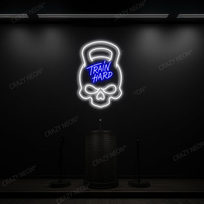blue and white train hard kettlebell neon sign mounted on a wall