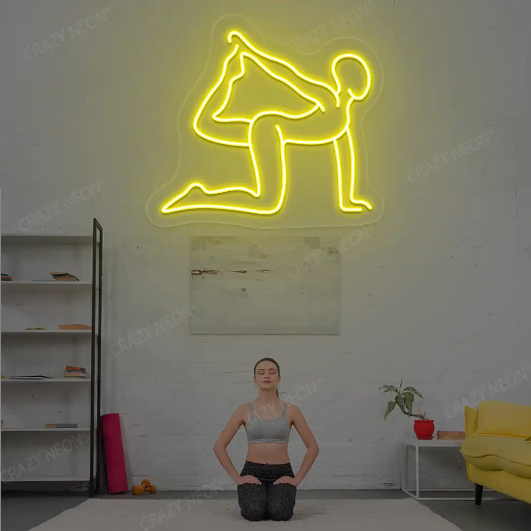 Eka Hasta Vyaghrasana Yoga Neon Sign glowing in yellow color in a yoga room