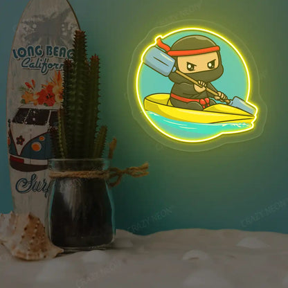 yellow ninja kayaking neon artwork mounted on a wall