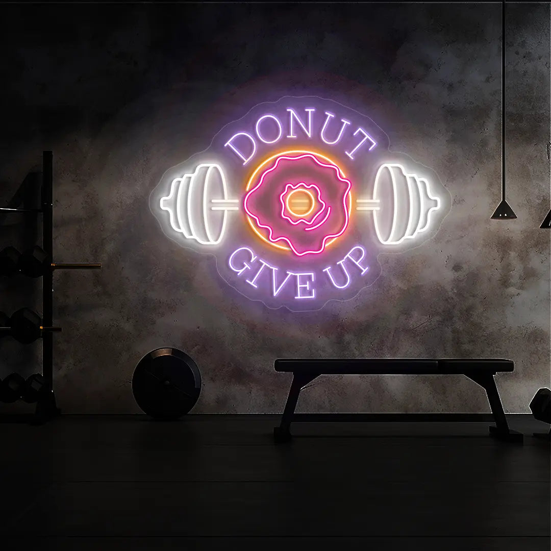 multi color donut give up gym neon sign mounted on a wall  
