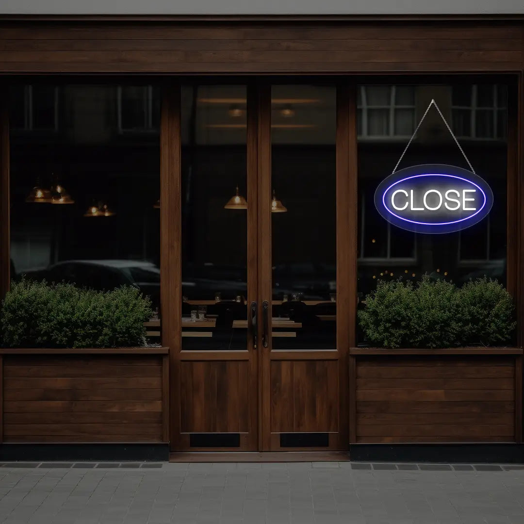blue oval close neon sign hanging on a window