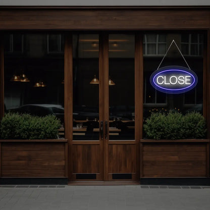 blue oval close neon sign hanging on a window