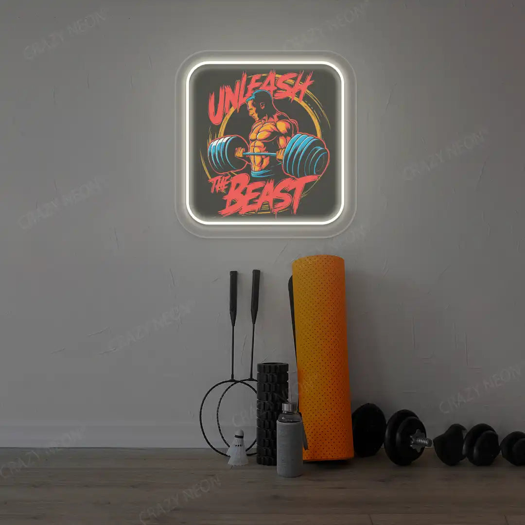 warm white unleash the beast gym neon artwork mounted on a wall