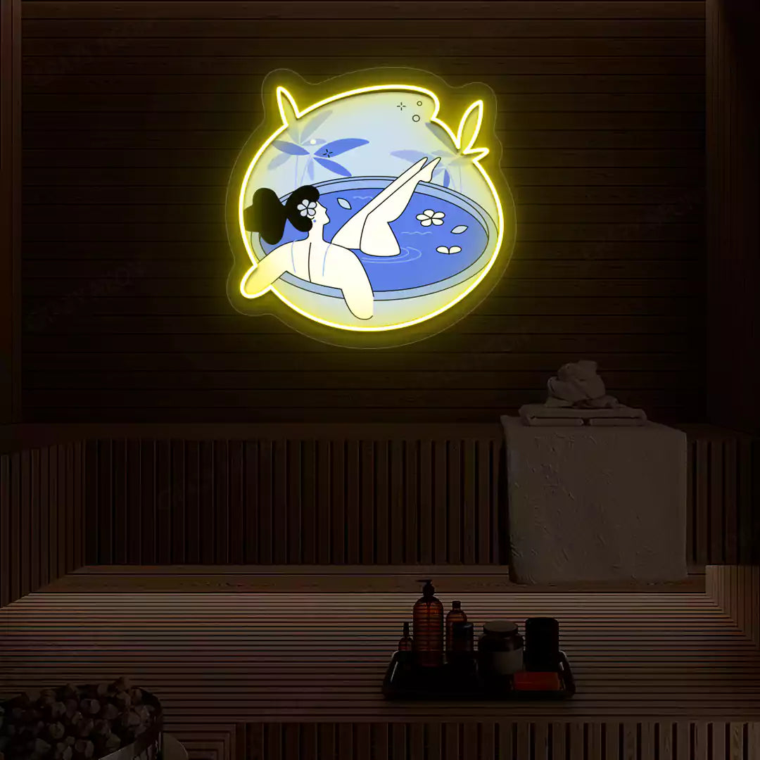Blue Blossom Bath Neon Artwork lighting up in yellow color on a wooden spa wall