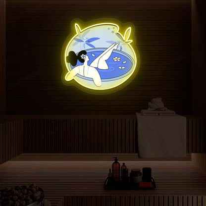 Blue Blossom Bath Neon Artwork lighting up in yellow color on a wooden spa wall
