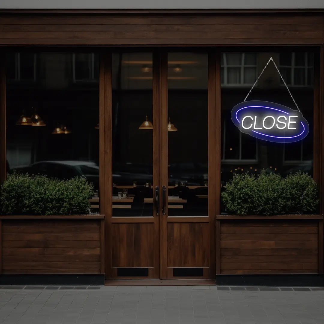 blue semi oval close neon sign hanging on a window