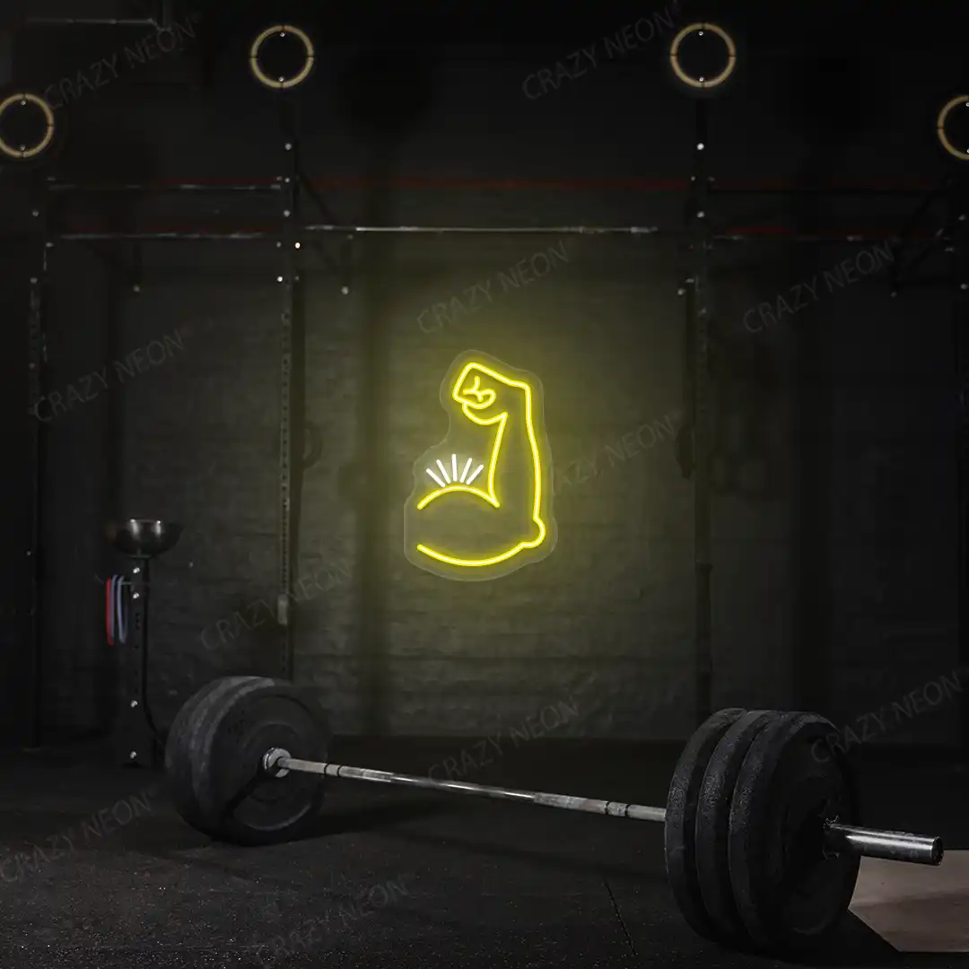 yellow and white bicep pump neon sign mounted on a wall