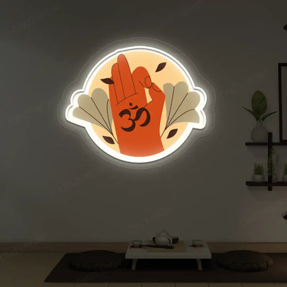 Om Gyan Mudra Neon Artwork lighting up in warm white color in a yoga room