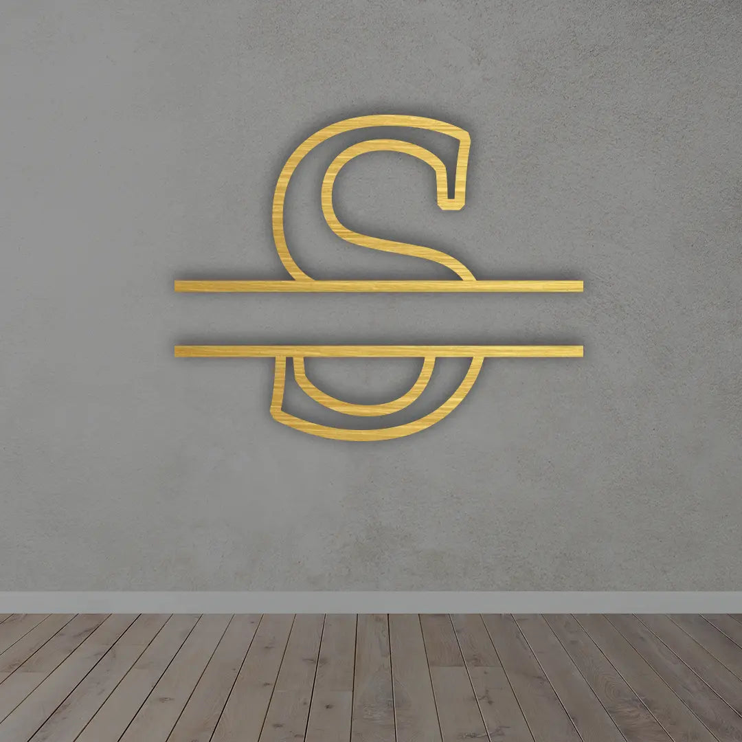 Split Letter Metal Monogram sign in Golden colour mounted on a wall