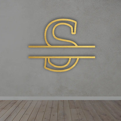 Split Letter Metal Monogram sign in Golden colour mounted on a wall