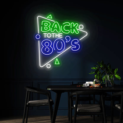 green blue and white back to the 80s vintage neon sign mounted on a wall