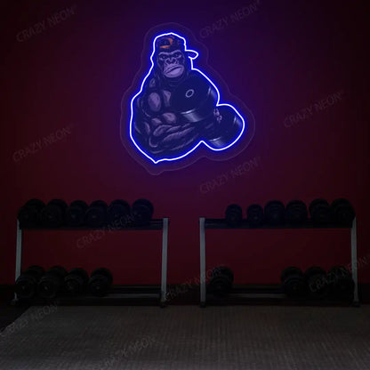 blue gorilla dumbbell lifting gym neon artwork mounted on a wall