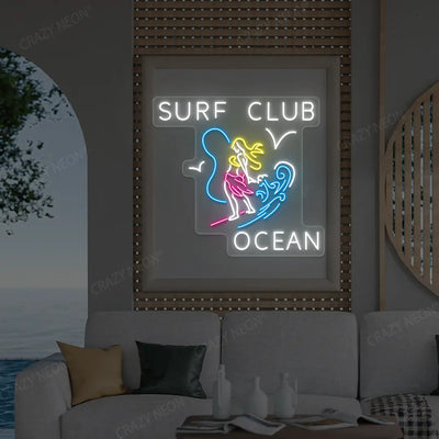 pink surf club ocean neon sign mounted on a wall