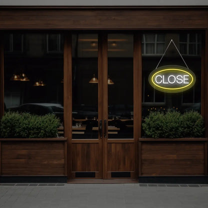 yellow oval close neon sign hanging on a window