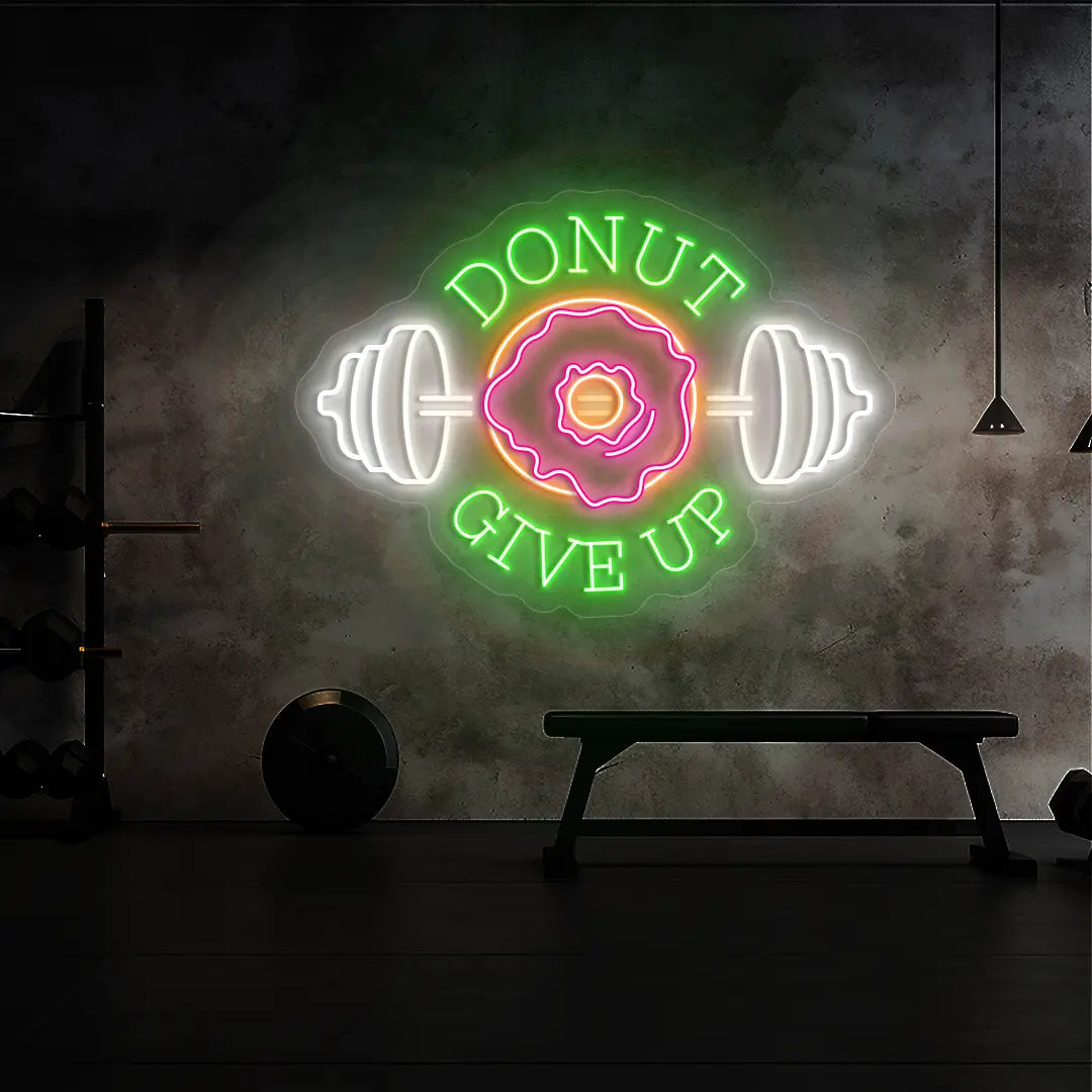 multi color donut give up gym neon sign mounted on a wall  