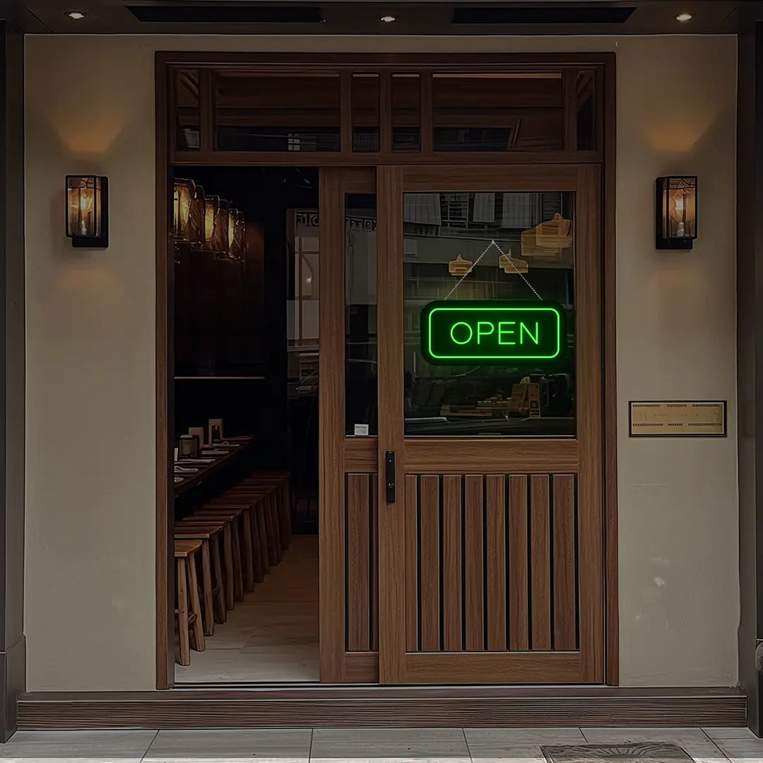 green open neon sign hanging on a shop door