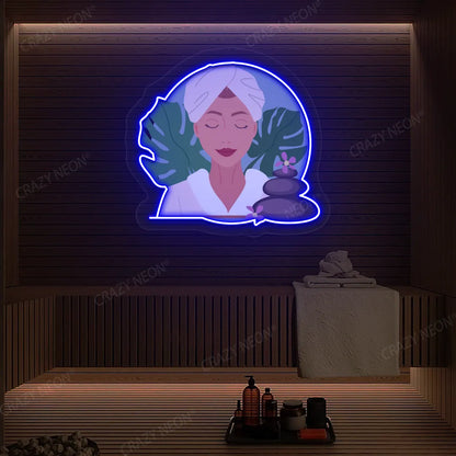 Zen Facial Spa Neon Artwork lighting up in blue color on a wooden spa wall