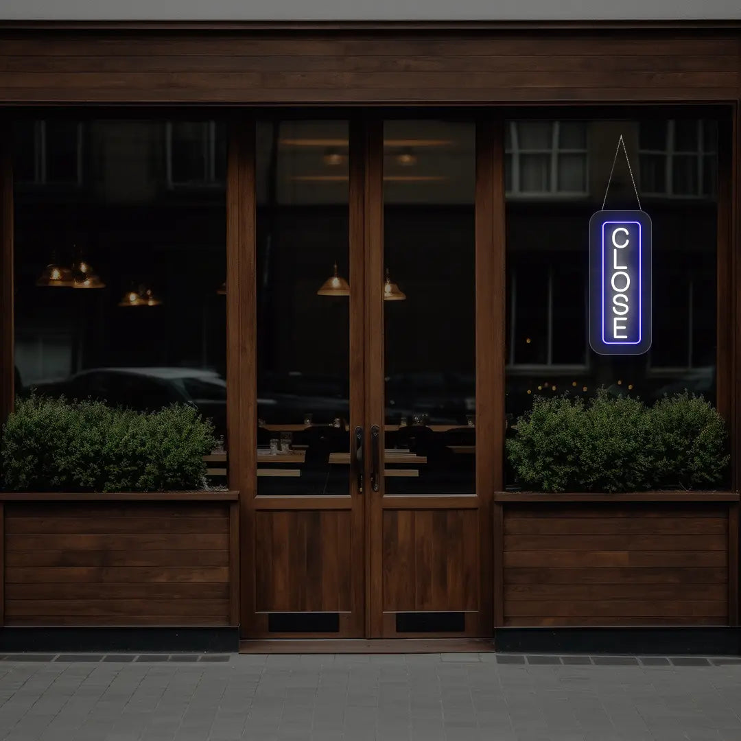 blue vertical close neon sign hanging on a window