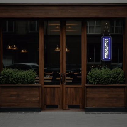 blue vertical close neon sign hanging on a window