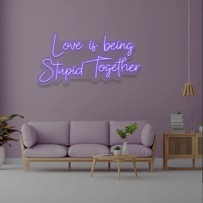 Love Is Being Stupid Together Neon Sign in Purple Color