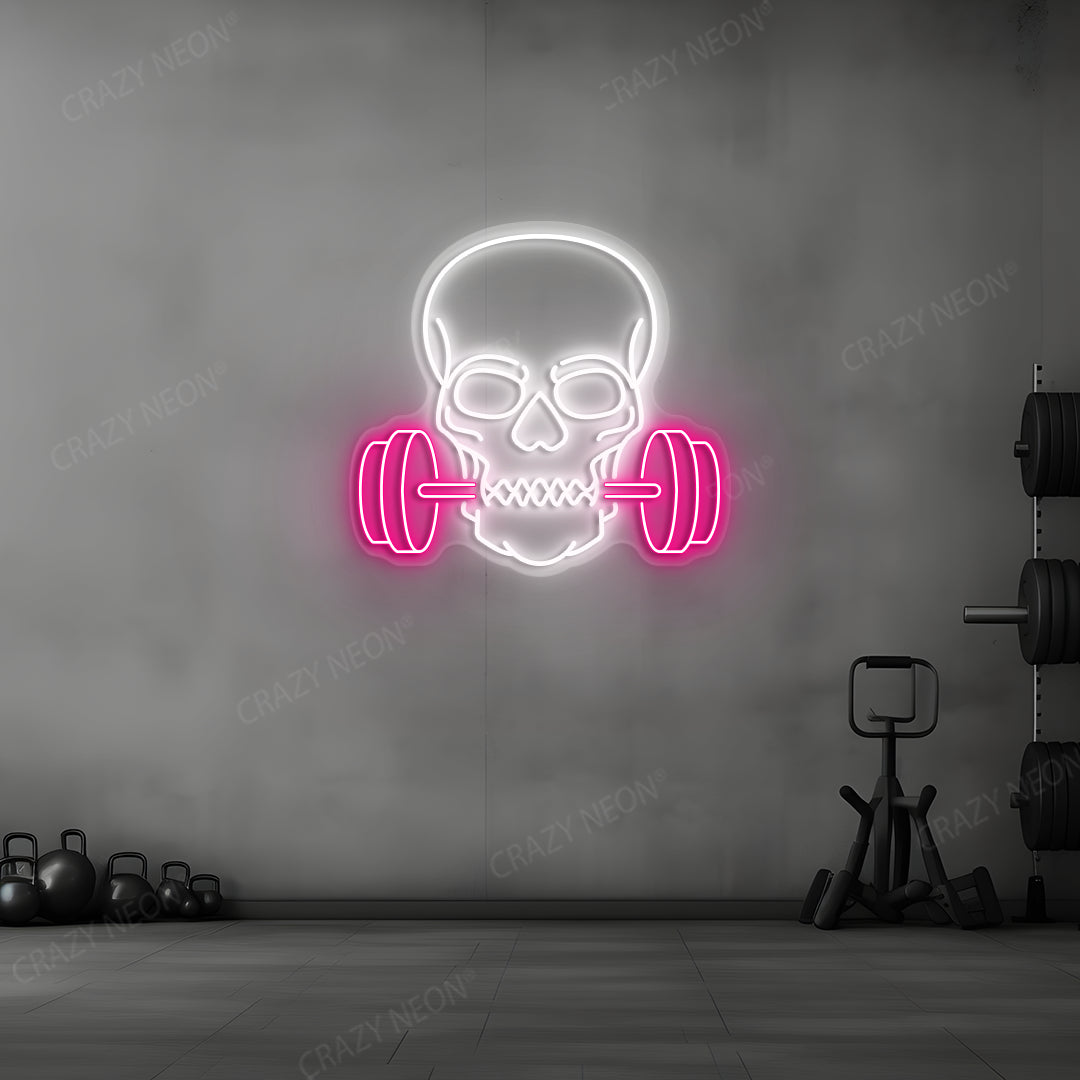 pink and white skull barbell gym neon sign mounted on a wall