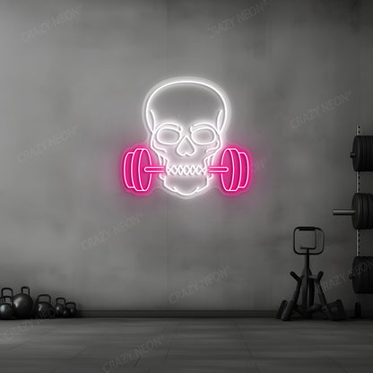 pink and white skull barbell gym neon sign mounted on a wall