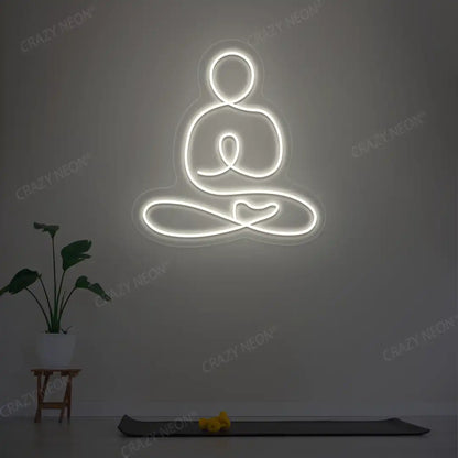 Swastikasana Yoga Neon Sign lighting up in warm white color in a yoga room