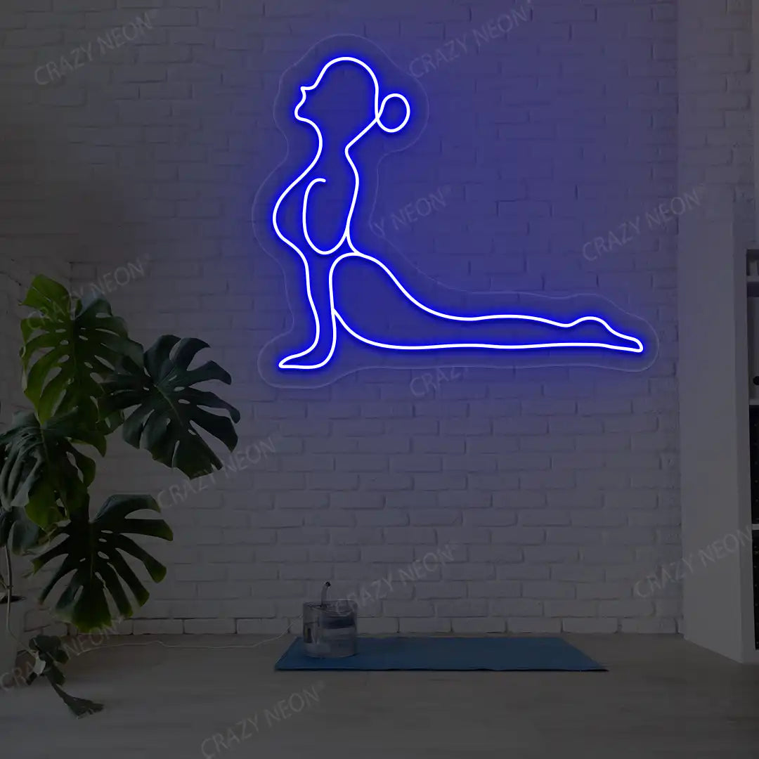Bhujangasana Yoga Neon Sign glowing in blue color in a yoga room