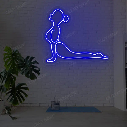 Bhujangasana Yoga Neon Sign glowing in blue color in a yoga room