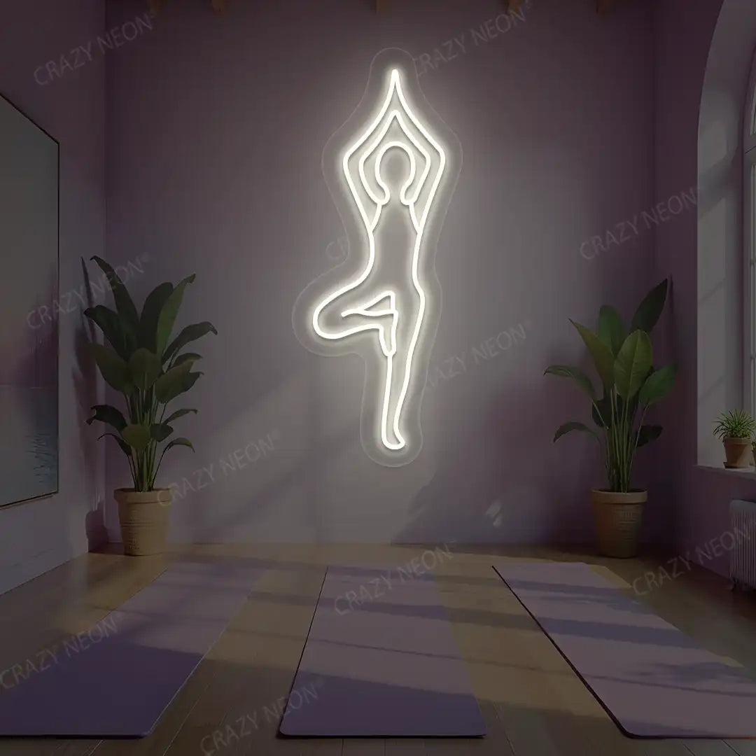 Vrikshasana Yoga Neon Sign lighting up in warm white color in a yoga room
