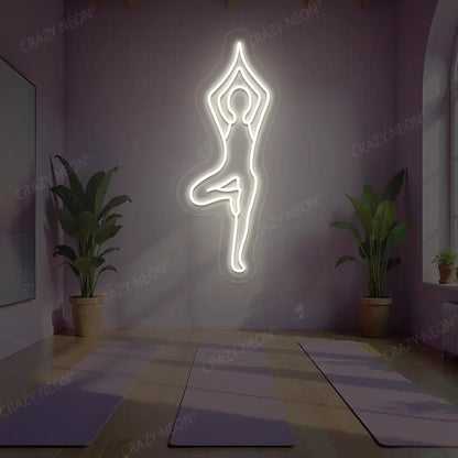 Vrikshasana Yoga Neon Sign lighting up in warm white color in a yoga room