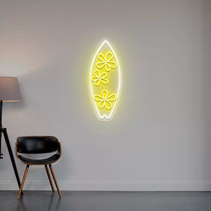 yellow and white floral surfboard neon sign mounted on a wall