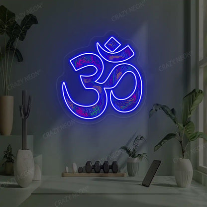 Psychedelic OM Neon Artwork lighting up in blue color in a yoga room