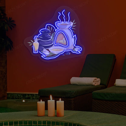 Spa Stones & Aromatherapy Neon Artwork lighting up in blue color on a spa wall