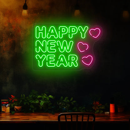 Happy New Year neon sign in green and pink heart lights mounted on a dark wall 