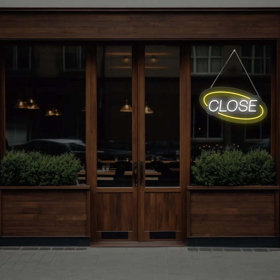 yellow semi oval close neon sign hanging on a window